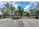 Gated community entrance with secure access, lush greenery, and visible signage for safety at 9713 Sweeping View Dr, New Port Richey, FL 34655