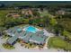 Aerial view of community pool and clubhouse, surrounded by lush landscaping and golf course views at 9713 Sweeping View Dr, New Port Richey, FL 34655