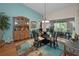 Bright dining area with glass table, hardwood floors, built-in cabinet, and sliding glass doors at 9713 Sweeping View Dr, New Port Richey, FL 34655