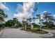 Welcoming view of Timber Greens' gated community entrance, with American flag and sign at 9713 Sweeping View Dr, New Port Richey, FL 34655