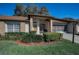 Charming single-story home featuring a well-manicured lawn and a cozy front porch with attractive landscaping at 9713 Sweeping View Dr, New Port Richey, FL 34655
