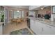 Bright kitchen and breakfast nook featuring granite countertops, stainless steel appliances, and large windows at 9713 Sweeping View Dr, New Port Richey, FL 34655