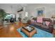 Spacious living room with dining area, hardwood floors, comfortable seating, and bright natural light at 9713 Sweeping View Dr, New Port Richey, FL 34655