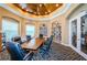 A meeting room featuring a large wooden table, leather chairs, built-in bookshelves, and decorative ceiling at 9713 Sweeping View Dr, New Port Richey, FL 34655