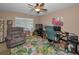 Comfortable office space with a plush recliner, desk, and tropical patterned carpet at 9713 Sweeping View Dr, New Port Richey, FL 34655