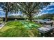 The shuffleboard court next to the parking area with tennis courts and trees in the background at 9713 Sweeping View Dr, New Port Richey, FL 34655