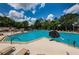 Large community swimming pool with lounge chairs and umbrellas for a relaxing outdoor experience at 9713 Sweeping View Dr, New Port Richey, FL 34655