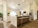 Modern kitchen with a marble-topped island, stainless steel appliances, and sleek bar stool seating at 1032 Concert Ave, Spring Hill, FL 34609