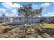 Large backyard with a door and chainlink fence at 10841 Scenic Dr, Port Richey, FL 34668