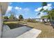 Large backyard featuring a concrete patio and chainlink fence at 10841 Scenic Dr, Port Richey, FL 34668