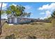 Spacious backyard with chainlink fence and rear door for potential outdoor activities at 10841 Scenic Dr, Port Richey, FL 34668