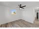 Bedroom features wood-look flooring, ceiling fan, and a closet at 10841 Scenic Dr, Port Richey, FL 34668
