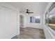 Bedroom includes wood-look floors, a ceiling fan, and a large closet at 10841 Scenic Dr, Port Richey, FL 34668