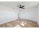 Spacious bedroom featuring light wood-look floors and double-door closet at 10841 Scenic Dr, Port Richey, FL 34668