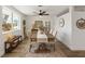 Well-lit dining room with hardwood floors, ceiling fan and stylishly decorated table at 10841 Scenic Dr, Port Richey, FL 34668