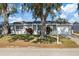 Well-maintained single-Gathering home featuring a garage and a neatly landscaped front yard at 10841 Scenic Dr, Port Richey, FL 34668