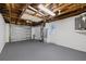Spacious garage with exposed rafters and a roll-up door at 10841 Scenic Dr, Port Richey, FL 34668