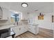 Bright kitchen featuring granite countertops, stainless appliances and white cabinets at 10841 Scenic Dr, Port Richey, FL 34668
