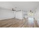 Open-concept living room with modern wood-look floors and a ceiling fan at 10841 Scenic Dr, Port Richey, FL 34668