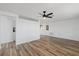 Large, brightly lit living room with sleek hardwood floors and an open layout, great for entertaining at 10841 Scenic Dr, Port Richey, FL 34668