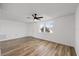 Inviting living room with natural light, wood-look floors and ceiling fan at 10841 Scenic Dr, Port Richey, FL 34668