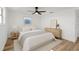 Cozy bedroom with natural wood floors, neutral decor, and ample natural light at 10841 Scenic Dr, Port Richey, FL 34668