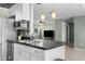 An open-concept kitchen island with views into a large living room at 10938 Water Oak Dr, Port Richey, FL 34668