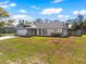 Charming single-story home with a two-car garage, stone accents, and manicured lawn against a blue sky backdrop at 11062 Tillburg St, Spring Hill, FL 34608