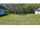 Spacious, green backyard with lush grass and mature trees at 11817 Bayonet Ln, New Port Richey, FL 34654