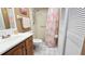 Bathroom featuring a walk-in shower, updated vanity, and white tile floors at 11817 Bayonet Ln, New Port Richey, FL 34654