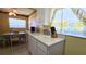 The eat-in kitchen features white cabinets and plenty of natural light from the window at 11817 Bayonet Ln, New Port Richey, FL 34654