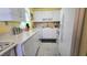 Cozy kitchen featuring white cabinets and appliances, perfect for cooking at 11817 Bayonet Ln, New Port Richey, FL 34654