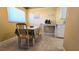 Eat-in kitchen featuring a dining table with seating and a window with natural light at 11817 Bayonet Ln, New Port Richey, FL 34654
