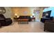 Spacious living room features tile flooring, stylish decor, and large windows at 11817 Bayonet Ln, New Port Richey, FL 34654