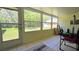 Well-lit sunroom with tiled floor and scenic backyard view at 11817 Bayonet Ln, New Port Richey, FL 34654