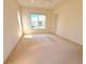 Bedroom featuring neutral carpeting and a window overlooking the outside at 12151 Putter Green Ct, New Port Richey, FL 34654
