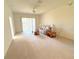 Bright living room with a ceiling fan, sliding glass doors and a comfortable sofa at 12151 Putter Green Ct, New Port Richey, FL 34654
