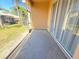Enclosed patio with sliding glass doors offers a relaxed view of the green backyard at 12151 Putter Green Ct, New Port Richey, FL 34654