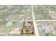 Aerial view of a single-story home inside property lines in a suburban neighborhood surrounded by lush greenery at 13140 Maycrest Ave, Weeki Wachee, FL 34614