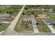 Aerial view of the property showcasing the home, driveway, and surrounding neighborhood at 13140 Maycrest Ave, Weeki Wachee, FL 34614