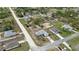 Aerial view of a single story home with a driveway and well-maintained lawn in a suburban neighborhood at 13140 Maycrest Ave, Weeki Wachee, FL 34614