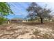 Large backyard showing a house, fence, and trees on a sunny day at 13140 Maycrest Ave, Weeki Wachee, FL 34614