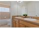 This bathroom has double sinks, framed cabinetry, and a view of the bath at 13140 Maycrest Ave, Weeki Wachee, FL 34614