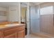 Spacious bathroom featuring a tiled shower with glass door and a vanity sink with ample storage space at 13140 Maycrest Ave, Weeki Wachee, FL 34614