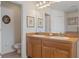 Functional bathroom featuring dual sinks, wood cabinetry, and ample counter space with a water closet nearby at 13140 Maycrest Ave, Weeki Wachee, FL 34614