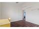 This bedroom has an open door, two floating shelves, and wood-look flooring at 13140 Maycrest Ave, Weeki Wachee, FL 34614