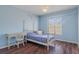 This bedroom is painted light blue and includes a four poster bed at 13140 Maycrest Ave, Weeki Wachee, FL 34614
