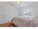 Bright bedroom with a door, large window, and hardwood-look flooring at 13140 Maycrest Ave, Weeki Wachee, FL 34614