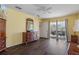 Sunny bedroom featuring dark wood floors and direct access to the outdoor patio at 13140 Maycrest Ave, Weeki Wachee, FL 34614