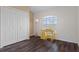 Bright bedroom features a closet, a charming yellow desk, and wood-look floors at 13140 Maycrest Ave, Weeki Wachee, FL 34614
